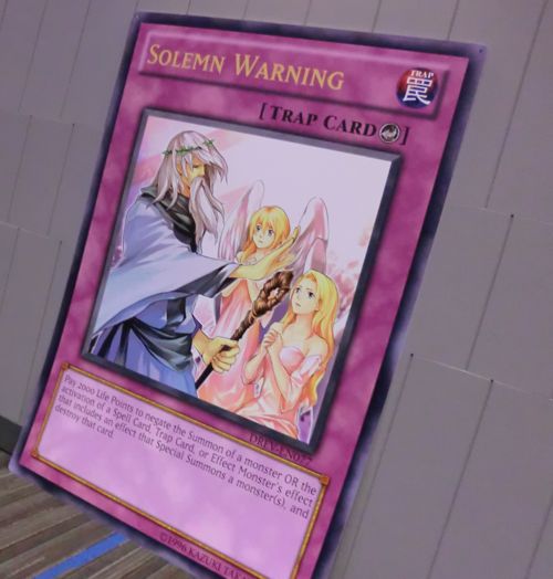 I need 3 Duelists to re-enact this scene this weekend, in front of this giant card. Send photos to us-ygorules@konami.com!